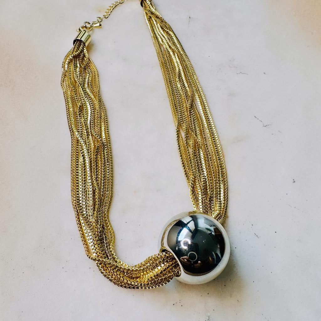 Jakris gold-tone multi-strand chain necklace featuring a large polished spherical ball pendant