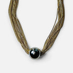Jakris multi-strand gold-tone steel chain necklace featuring a large central metallic sphere bead