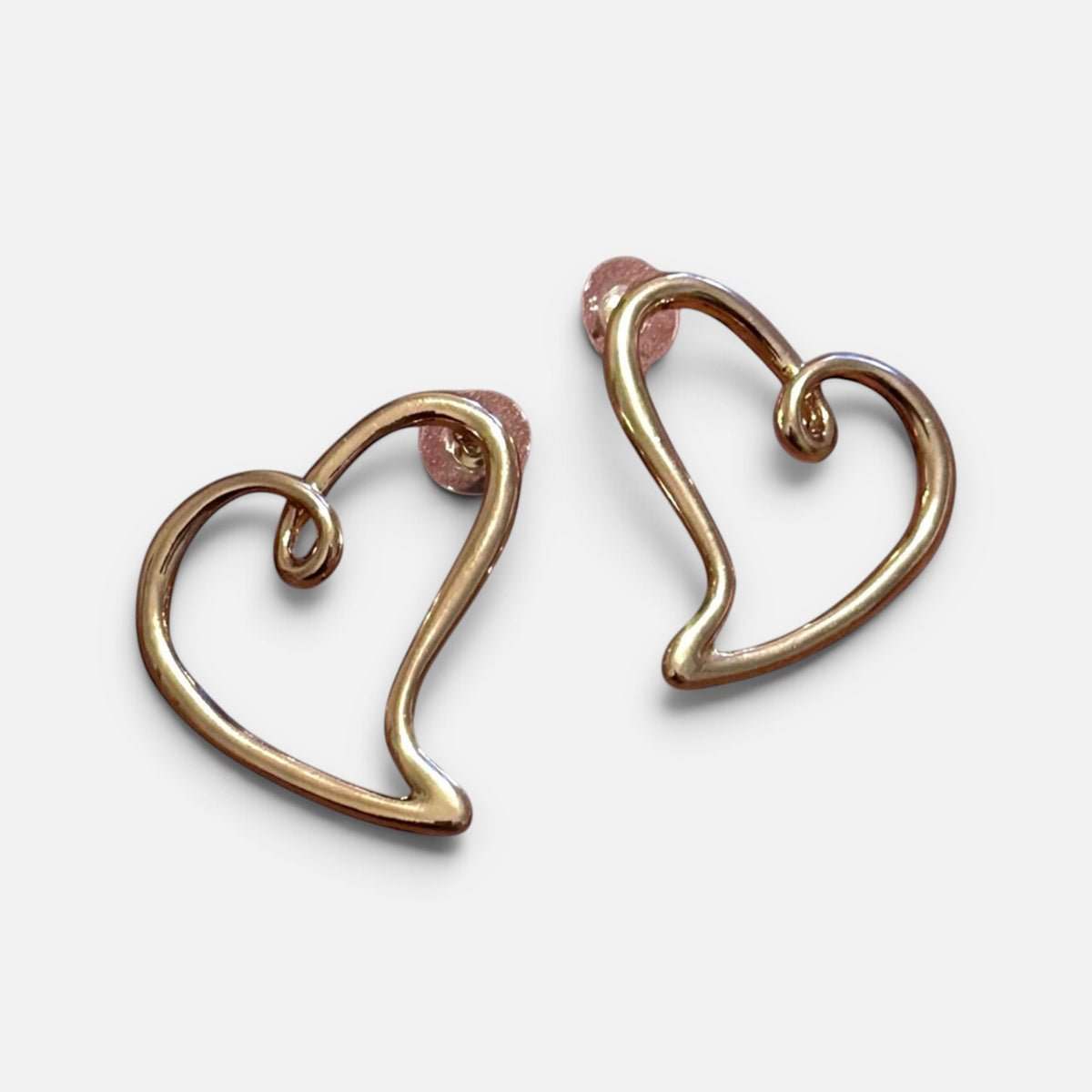 Jakris minimalist open heart stud earrings in polished gold, featuring a sleek and elegant design.