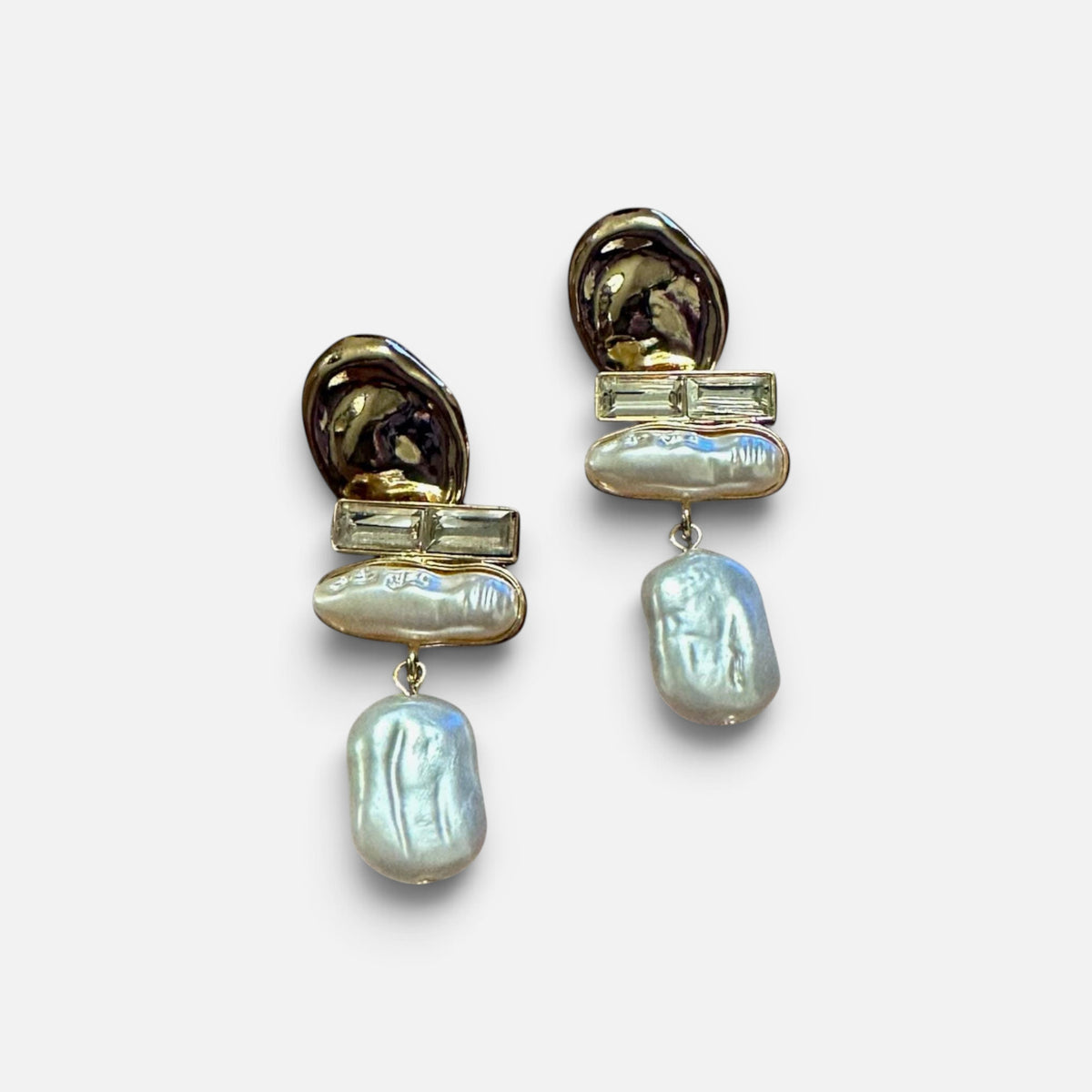 Jakris gold-toned dangling earrings featuring modern geometric metal accents and lustrous baroque pearls
