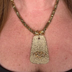 Jakris gold-plated brass necklace featuring a textured pendant with an evil eye motif and geometric beaded chain