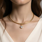 Jakris gold-plated choker necklace featuring a round solitaire crystal pendant worn on a model