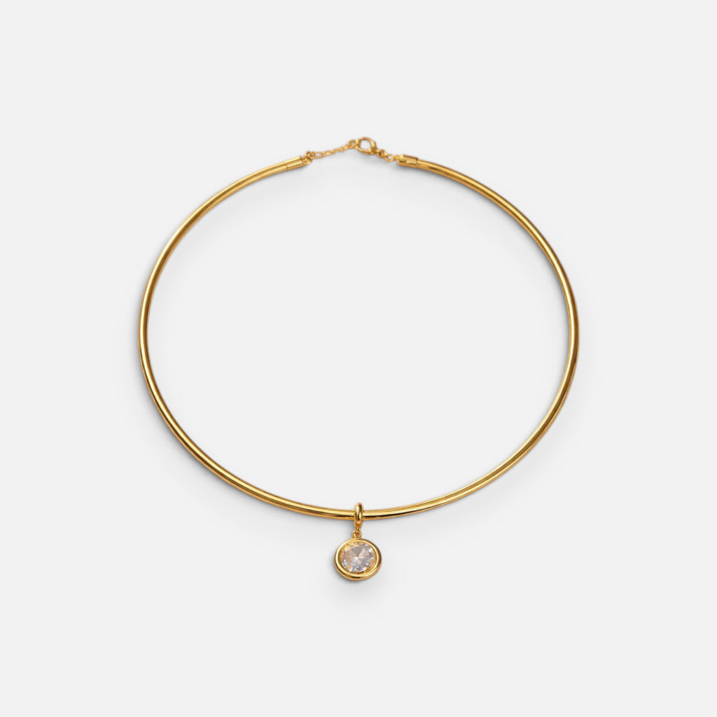 Jakris gold-plated choker necklace featuring a delicate round solitaire pendant on a minimalist metal band