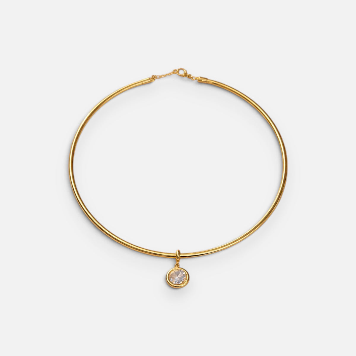 Jakris gold-plated choker necklace featuring a delicate round solitaire pendant on a minimalist metal band