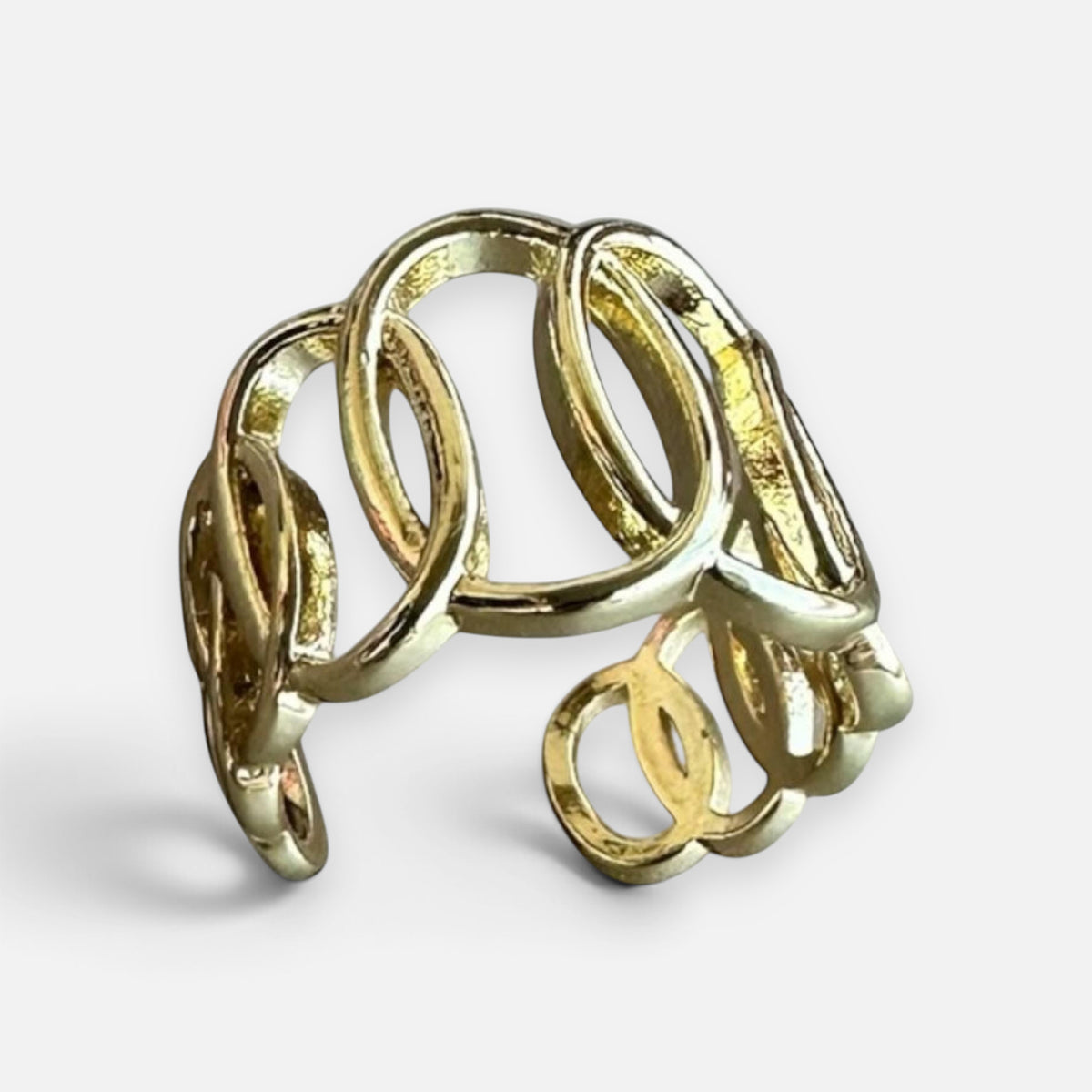 Jakris gold-plated adjustable spiral ring with a sculptural open-form design