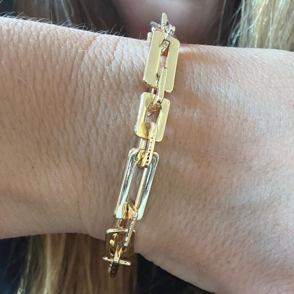 Jakris gold-tone geometric rectangular link chain bracelet worn on a wrist