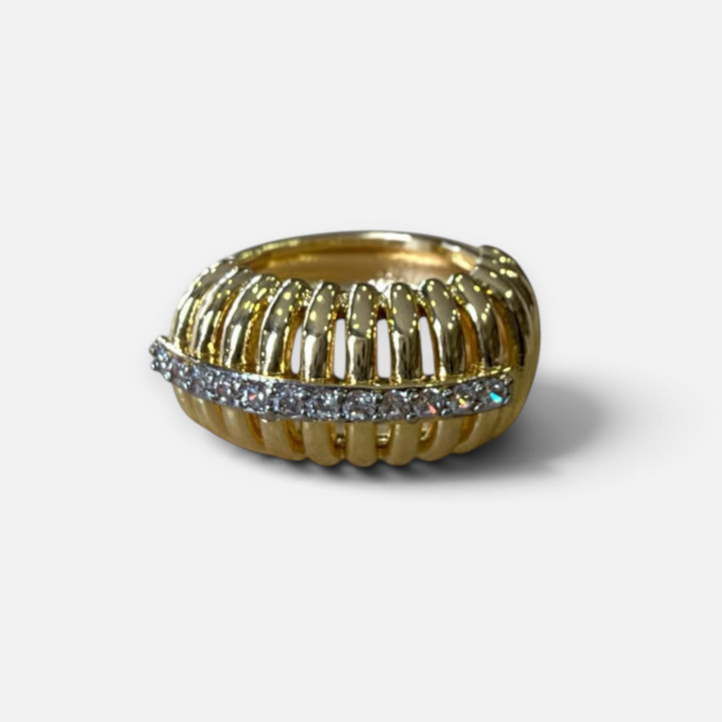 Jakris gold-tone ear cuff featuring a ribbed cage design with a central row of sparkling clear crystals.