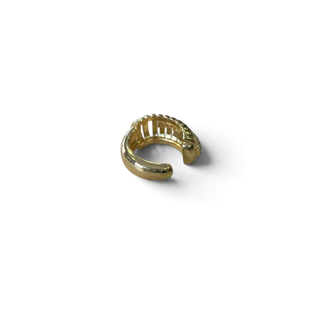 Jakris gold-tone ear cuff featuring a ribbed cage design with a central row of clear crystals for a modern look.