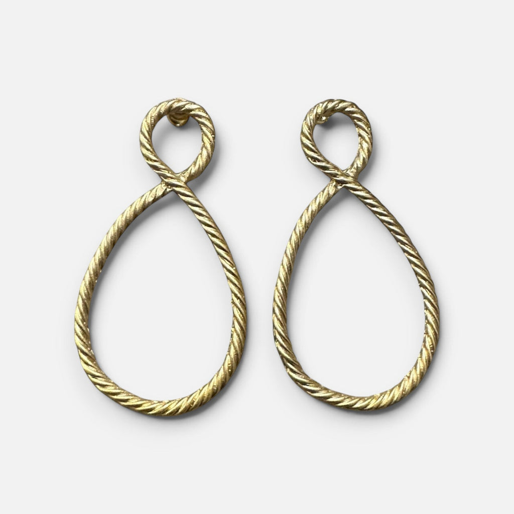 Jakris gold-plated earrings featuring a twisted rope design in a teardrop shape on a white surface.