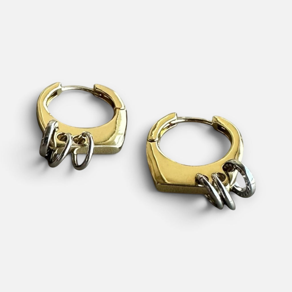 Jakris modern gold-tone hoop earrings featuring small silver-tone ring charms in a geometric design