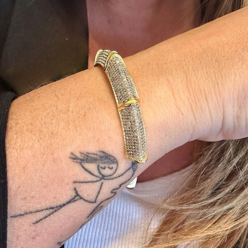 Jakris gold and silver cuff bracelet featuring sparkling zircon stones worn on a wrist