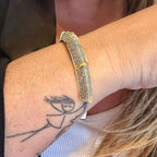 Jakris gold and silver cuff bracelet featuring sparkling zircon stones worn on a wrist