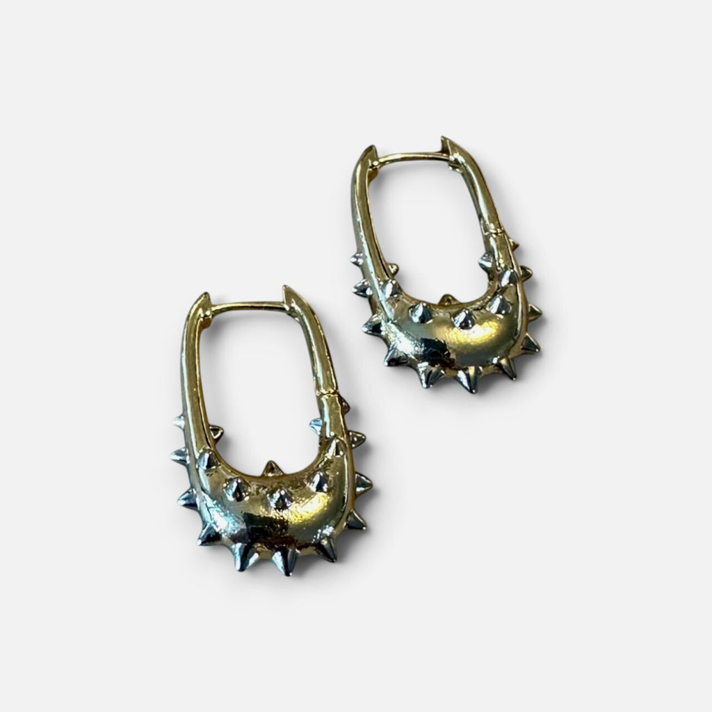 Jakris gold hoop earrings featuring a unique U-shape design with edgy silver-toned metal spikes.