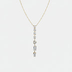 Jakris gold necklace featuring a vertical drop design with various shaped clear stones on a delicate chain