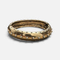 Jakris gold-toned cuff bracelet featuring a studded design with a vintage metallic finish