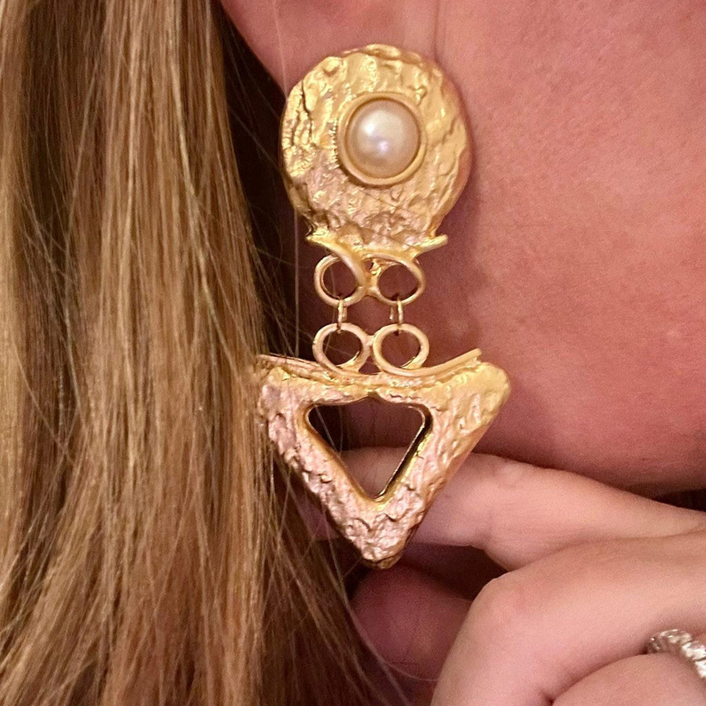 Jakris gold-toned dangling earrings featuring a textured geometric triangle design and a central pearl accent.