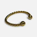 Jakris gold twisted cuff bracelet featuring a delicate pearl accent at the open end