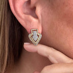 Jakris gold-plated Art Deco arrow stud earring featuring sparkling zircon stones worn on a model's earlobe
