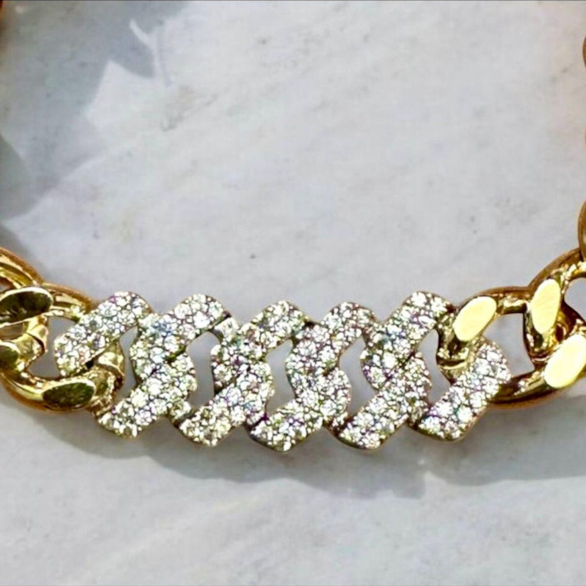 Jakris gold chain bracelet featuring a thick link design embellished with sparkling white zircon stones