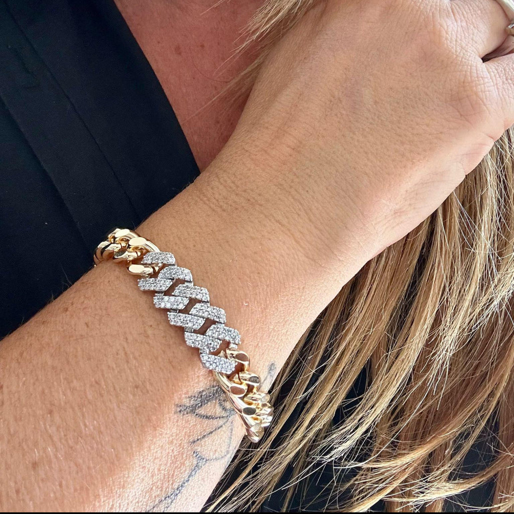 Jakris gold chain bracelet featuring a thick link design adorned with sparkling white zircon stones on a woman's wrist