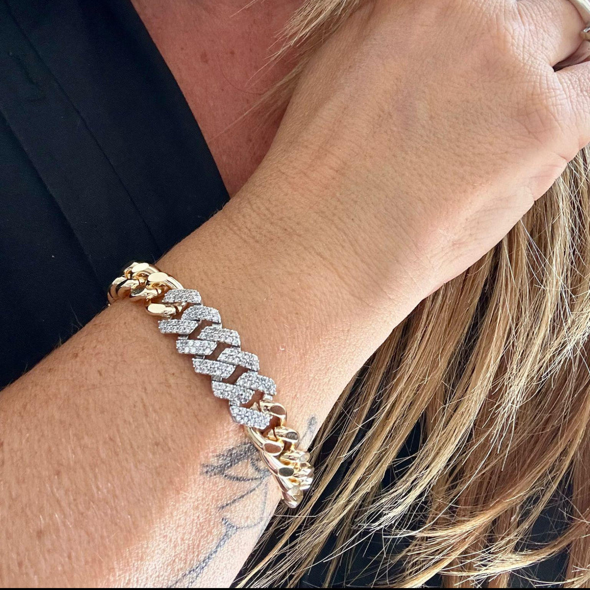 Jakris gold chain bracelet featuring a thick link design adorned with sparkling white zircon stones on a woman's wrist