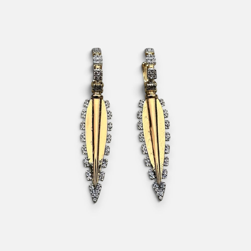 Jakris gold-plated long drop earrings featuring intricate zircon stone detailing on a white display stand.