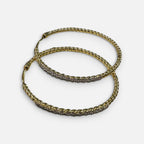 Jakris gold hoop earrings featuring a twisted design and sparkling zircon stone accents for an elegant look