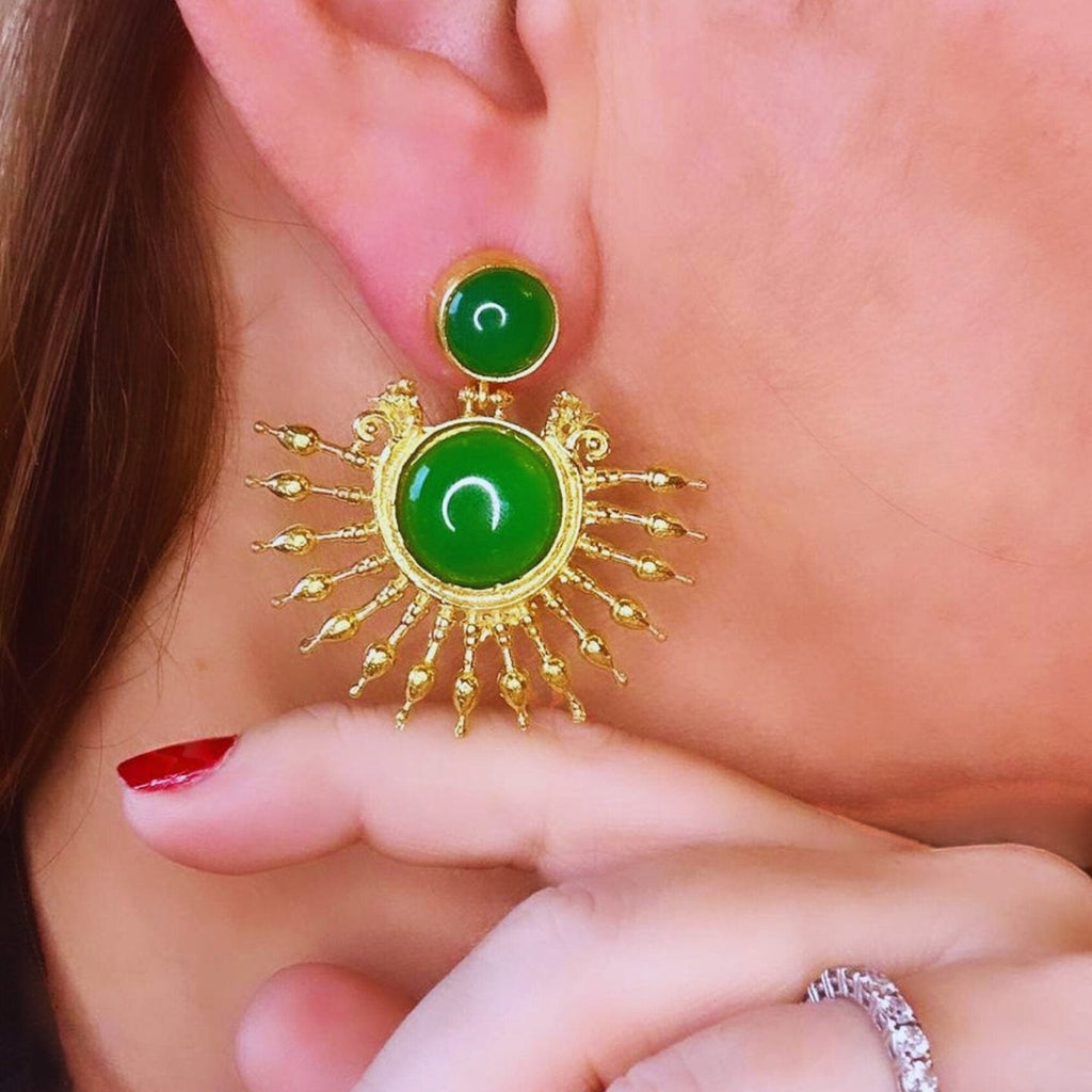 Jakris green onyx stone drop earrings with 24k gold plated sunburst design worn on a woman's ear