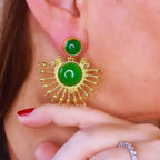 Jakris green onyx stone drop earrings with 24k gold plated sunburst design worn on a woman's ear