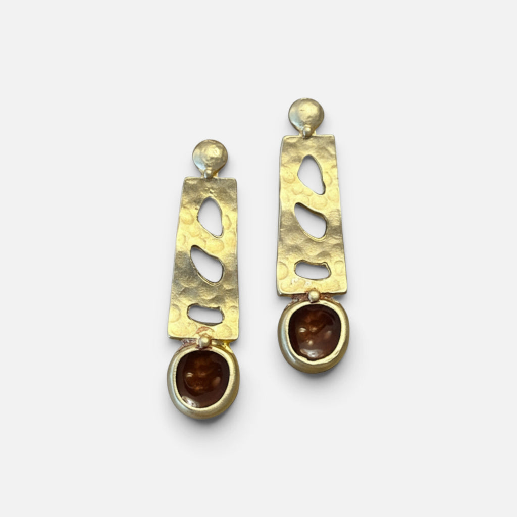 Jakris gold-tone drop earrings featuring a hammered metal texture and brown stone accents in a modern design.