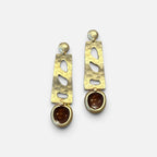 Jakris gold-tone drop earrings featuring a hammered metal texture and brown stone accents in a modern design.
