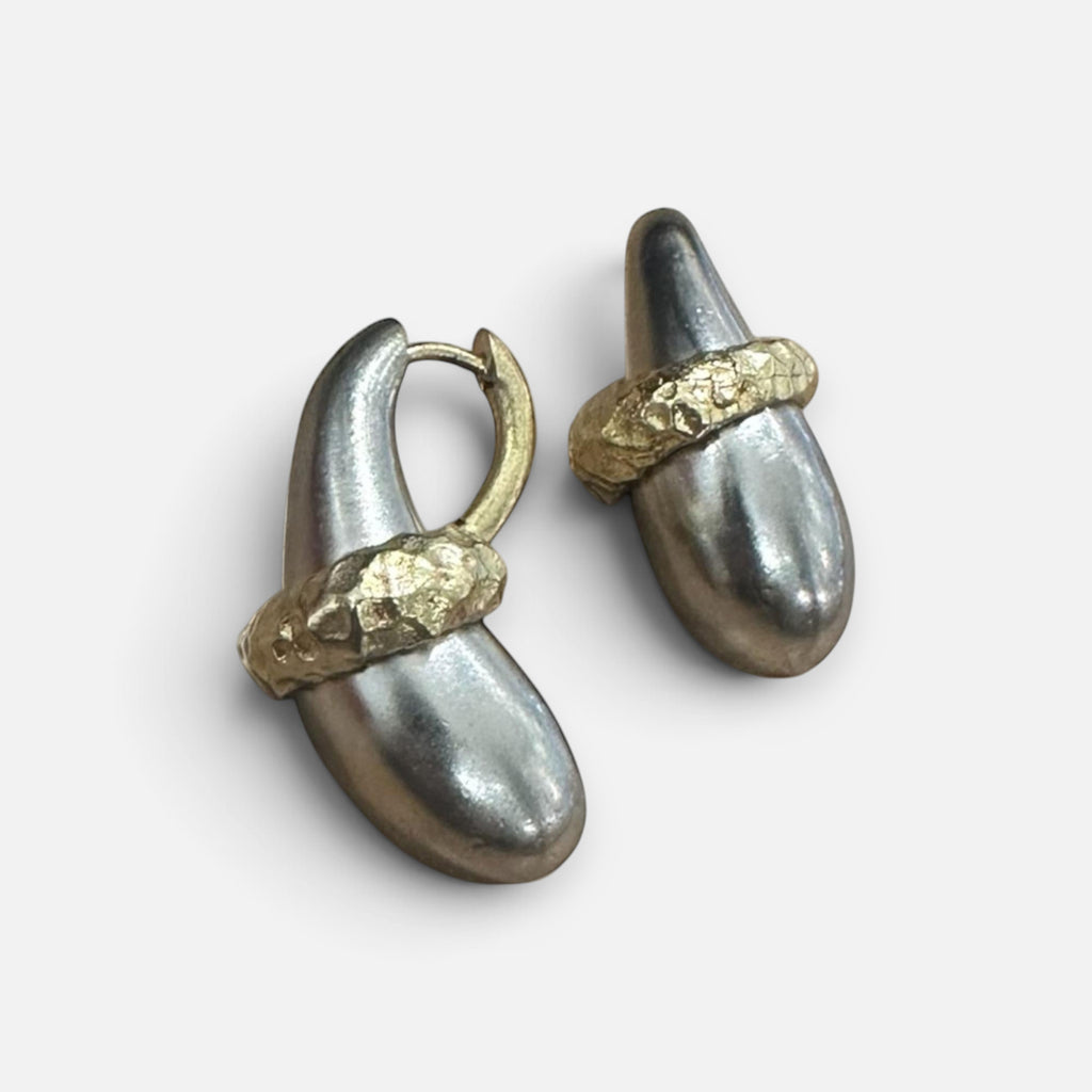 Jakris handmade sculptural earrings in brass with white gold plating and textured gold-tone accents.