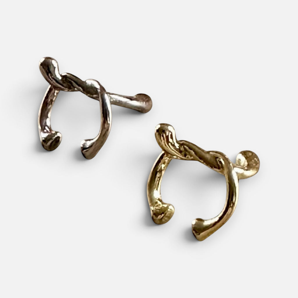 Jakris minimalist knot cartilage earrings in gold and silver tones with a polished metallic finish