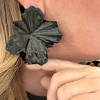 Jakris large black flower statement earring worn on ear with textured petal design
