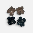 Jakris large flower earrings in brown and black with textured petal details on a white fabric background