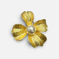 Jakris large gold-tone flower brooch featuring a central white pearl and a textured hammered metal finish.