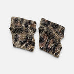 Jakris statement earrings featuring a sculptural, irregular shape with gold-tone, black, and champagne crystal leopard print.