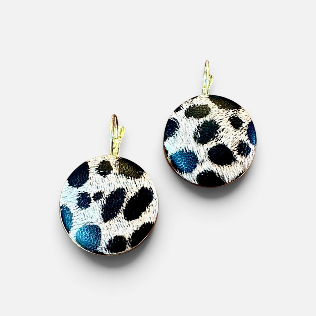 Jakris round dangle earrings featuring a black and white leopard animal print pattern on a textured surface