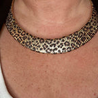 Jakris double-sided choker necklace featuring a gold-toned textured finish and a bold leopard print pattern.