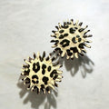 Jakris round earrings featuring a beige and black leopard print pattern with a textured, serrated edge design