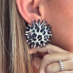 Jakris round statement earring featuring a black and white leopard print center with a spiky, serrated edge design.