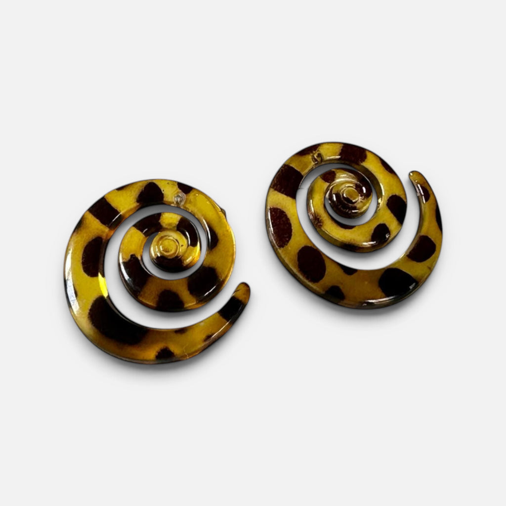 Jakris tortoiseshell spiral earrings with a brown and black leopard print pattern on a white surface.