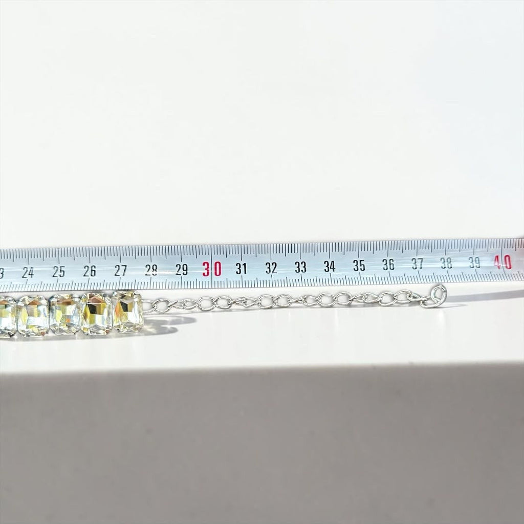 Jakris Liora choker necklace featuring emerald-cut crystals and an adjustable silver-tone extension chain on a ruler.