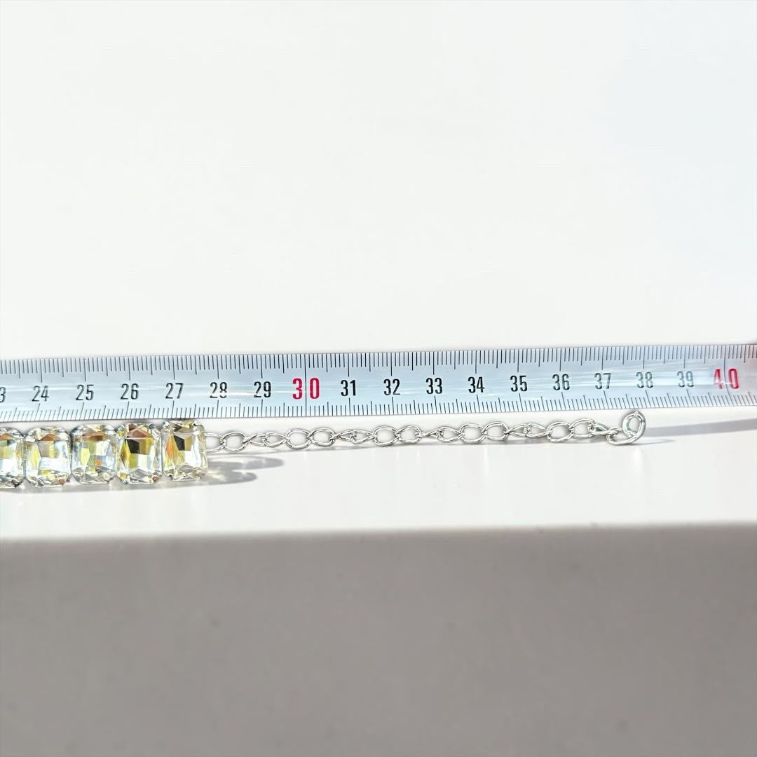 Jakris Liora choker necklace featuring emerald-cut crystals and an adjustable silver-tone extension chain on a ruler.