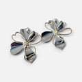 Jakris mixed metal flower earrings featuring silver petals with gold-tone centers in a lightweight floral design