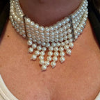 Jakris multi-strand pearl choker necklace featuring elegant dangling pearl accents for bridal or formal wear.