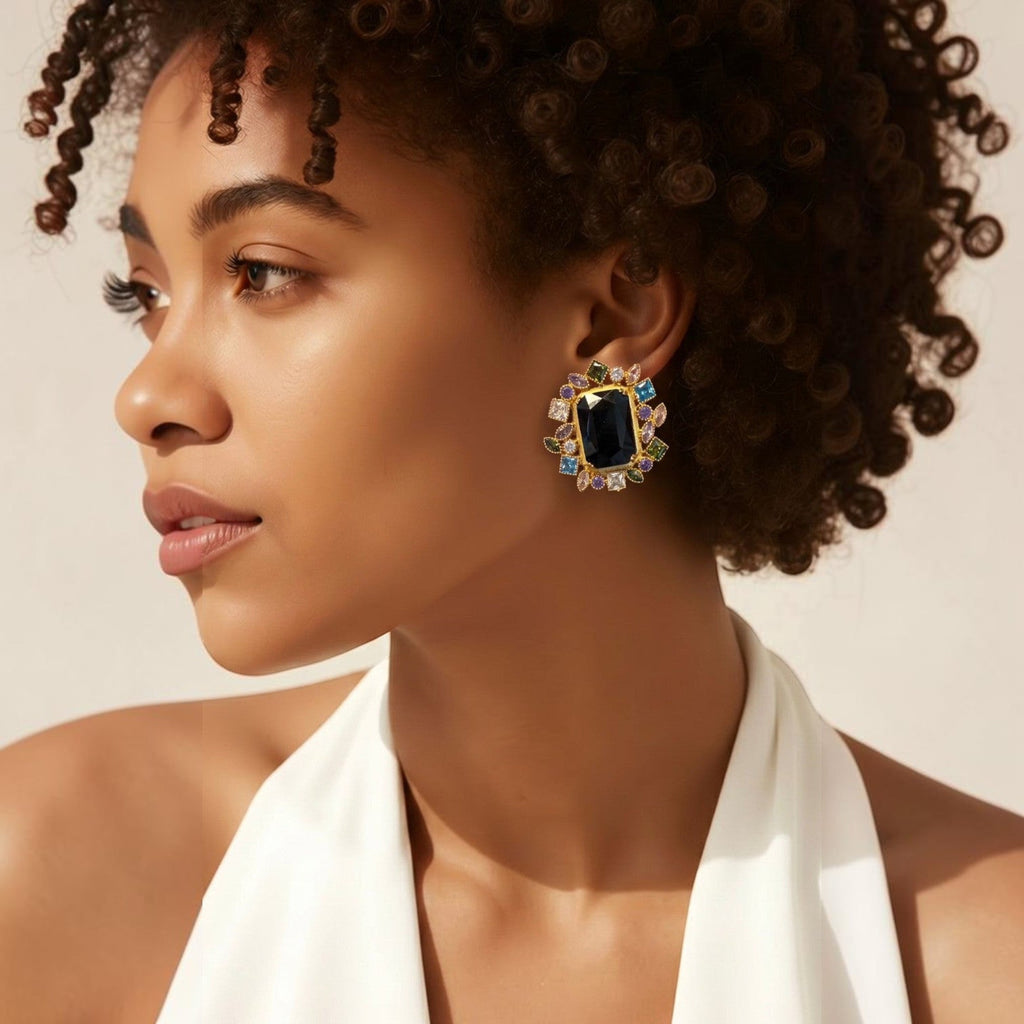 Jakris onyx stone earrings featuring a large black center stone surrounded by colorful zircon crystals on a model