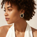 Jakris onyx stone earrings featuring a large black center stone surrounded by colorful zircon crystals on a model
