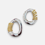 Jakris oval silver earrings featuring decorative gold-tone chain detailing for a modern two-tone look.