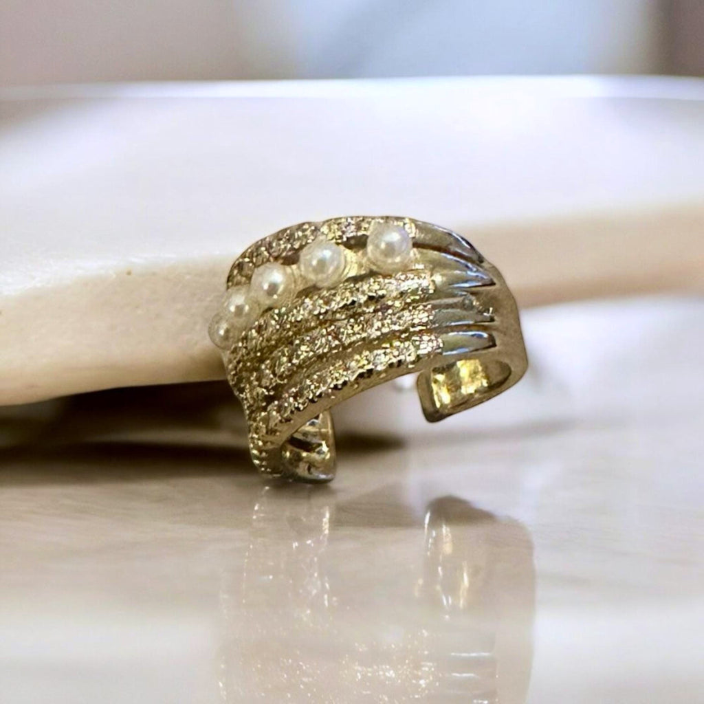 Jakris gold-tone non-pierced ear cuff featuring delicate white pearls and sparkling crystal stone embellishments.
